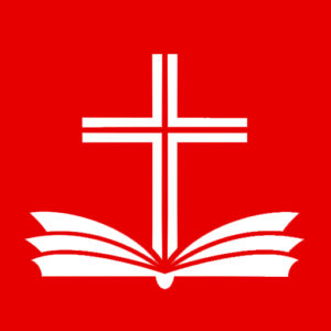 A picture of a red square with a white Bible and cross in the center